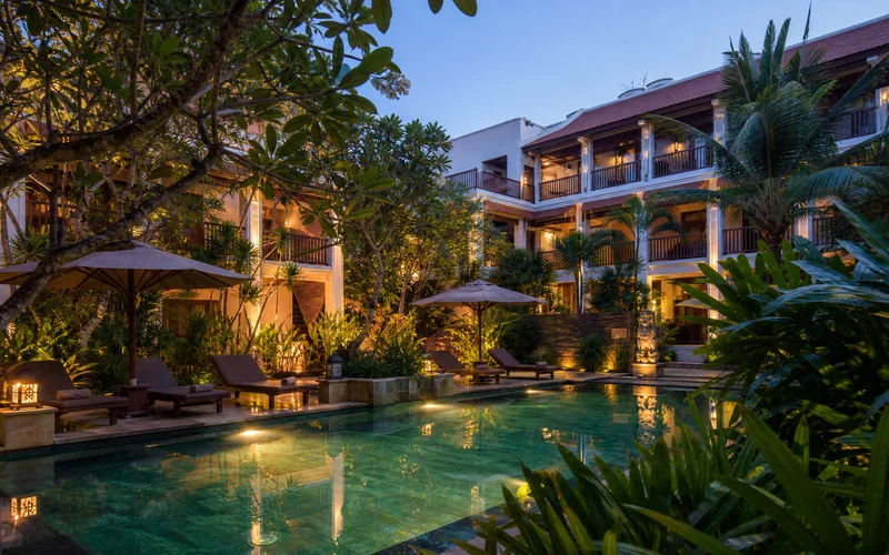 AI-generated editorial hotel courtyard and pool inspired by Pandora Suite D'Angkor in Siem Reap, Cambodia